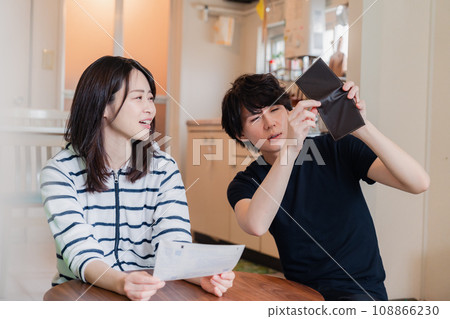 A young couple looks at their bill details and suffers from price hikes. 108866230