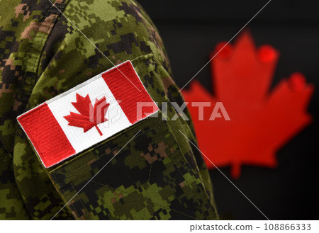 Canada Day. Flag of Canada on the military uniform and red Maple leaf on the background. Canadian soldiers. Army of Canada. Canada leaf. Remembrance Day. Poppy day. 108866333