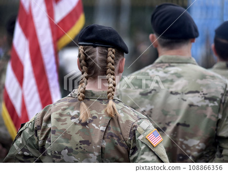 American Soldiers looks on the US flag. US Army. Military forces of the United States of America. Memorial day. Veterans Day. 108866356
