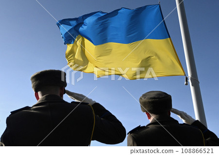 Ukrainian soldiers giving salute. Flag of Ukraine. Armed Forces of Ukraine. Ukrainian army. 108866521