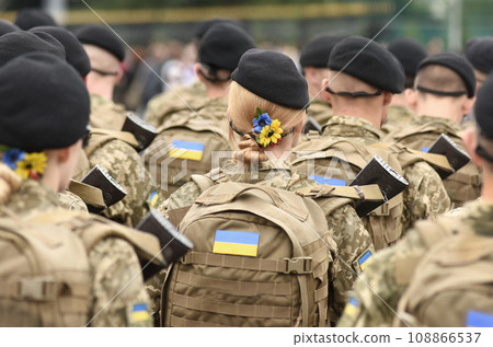 Woman soldier. Woman in army. Ukrainian flag on military uniform. Ukraine troops. 108866537