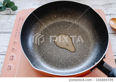 Sesame oil heated in a frying pan Sesame oil heated in a frying pan 108866599