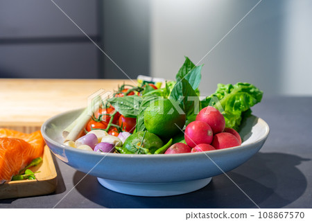 Ingredients of Spicy salad are prepared on black granite top table with various vegetable and herb. Ingredients of Spicy salad are prepared on black granite top table with various vegetable and herb. 108867570