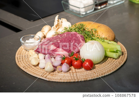 close up to Raw Ingredients for beef steak and mushroom sauce menu on circle wicker plate. 108867578