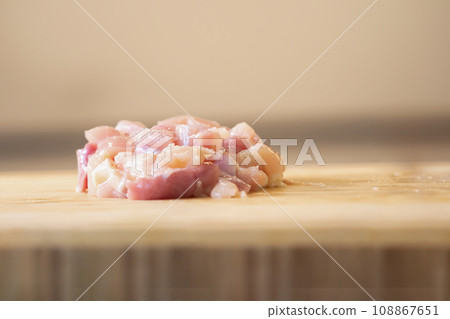 Close up to raw minced chicken on wood plate. It is prepared for cooking Thai Menu like Coconut Milk Chicken Soup. 108867651
