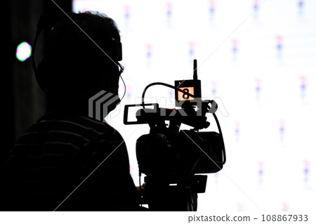 Asian man Videographer in backside are shooing and recording video in Speech event on the stage. Asian man Videographer in backside are shooing and recording video in Speech event on the stage. 108867933