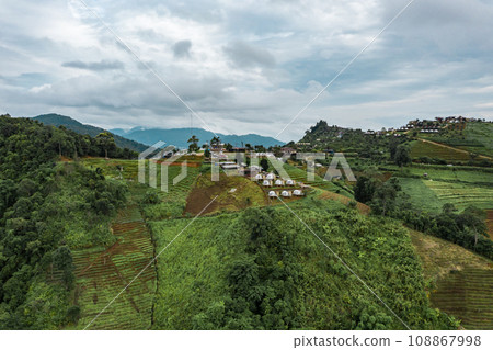 An aerial photographic view of Mon Jam Village in Chiangmai, filled with houses, resorts, and homestays for all the visitors. 108867998