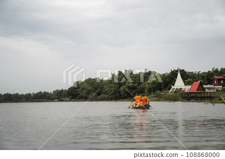 2 monks rowing along the river to receive alms in the morning. 2 monks rowing along the river to receive alms in the morning. 108868000