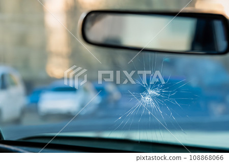 AI-generated image of a car windshield cracked by a rock AI-generated image of a car windshield cracked by a rock 108868066