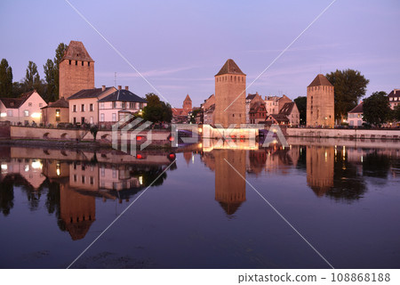 Ponts Couverts in Strasbourg, France. The bridges and three towers of the Ponts Couverts in Strasbourg. Strasbourg cityscape at night. Ponts Couverts in Strasbourg, France. The bridges and three towers of the Ponts Couverts in Strasbourg. Strasbourg cityscape at night. 108868188
