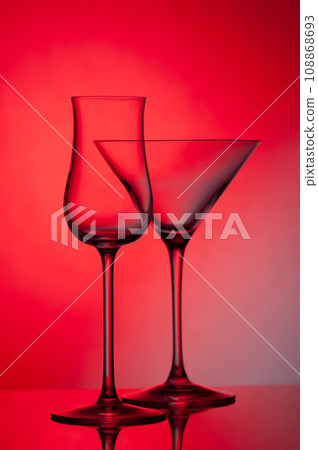 Empty glass wine glass on a red background. Empty glass wine glass on a red background. 108868693