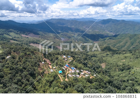 High angle view of a northern rural village in the valley Ban Thung Ton Ngio, Mae Tuen, Omkoi district, Chiang Mai, Thailand. High angle view of a northern rural village in the valley Ban Thung Ton Ngio, Mae Tuen, Omkoi district, Chiang Mai, Thailand. 108868831