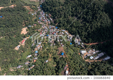 High angle view of a northern rural village in the valley Ban Thung Ton Ngio, Mae Tuen, Omkoi district, Chiang Mai, Thailand. High angle view of a northern rural village in the valley Ban Thung Ton Ngio, Mae Tuen, Omkoi district, Chiang Mai, Thailand. 108868840