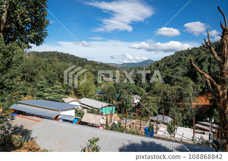 High angle view of a northern rural village in the valley Ban Thung Ton Ngio, Mae Tuen, Omkoi district, Chiang Mai, Thailand. High angle view of a northern rural village in the valley Ban Thung Ton Ngio, Mae Tuen, Omkoi district, Chiang Mai, Thailand. 108868842
