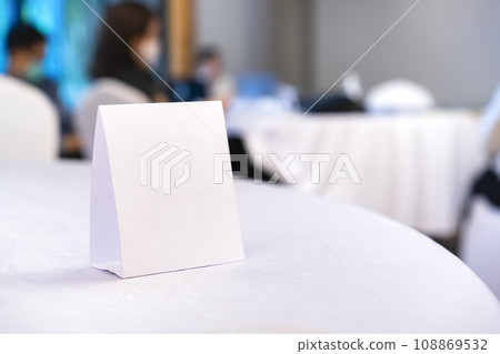 Triangular shaped table sign is placed on the table for scanning QR codes as an announcement, reservation sign, or menu at the seminar. Triangular shaped table sign is placed on the table for scanning QR codes as an announcement, reservation sign, or menu at the seminar. 108869532