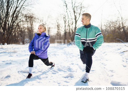 Young couple winter morning exercise at snowy forest. Healthy fitness lifestyle. Sport, Active life. 108870315