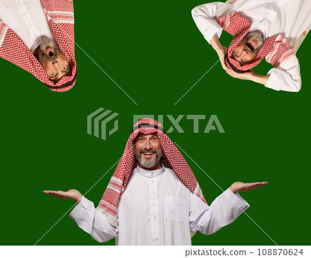 Smiling Arab man expresses happiness and makes choice, creating empty blank space for your text. Isolated on green background, radiates positivity, contentment, and joy of making decisions. High 108870624