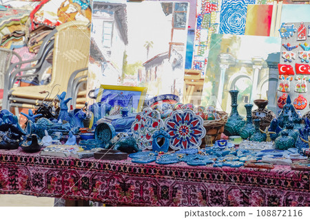 Trading table with souvenirs and paintings for tourists. 108872116