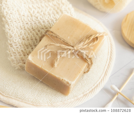 Beige handmade soap bar on soap saver bag close up, mockup Beige handmade soap bar on soap saver bag close up, mockup 108872628