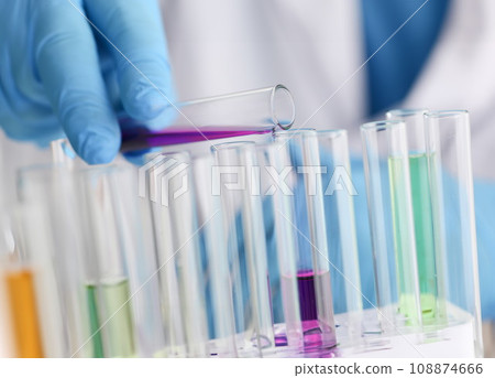 A male chemist holds test tube of glass A male chemist holds test tube of glass 108874666