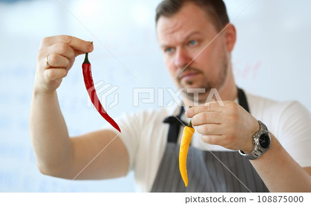 Professional Chef Showing Yellow Chili Pepper Professional Chef Showing Yellow Chili Pepper 108875000