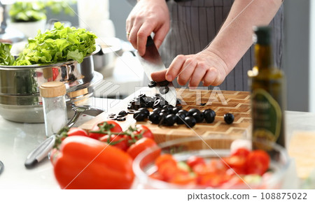 Male Hands Chopping Round Black Olives Slices Male Hands Chopping Round Black Olives Slices 108875022