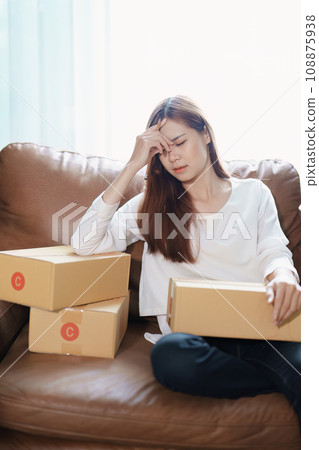 Starting small business entrepreneur of independent Asian woman showing her face worried about the sales of her business not reaching the target set. SME concepts. Starting small business entrepreneur of independent Asian woman showing her face worried about the sales of her business not reaching the target set. SME concepts. 108875938