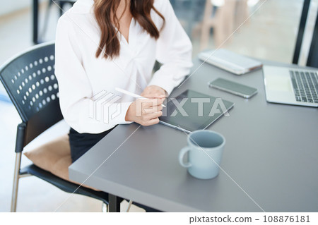 business owner or Asian female marketers are using tablet computer in office work. 108876181