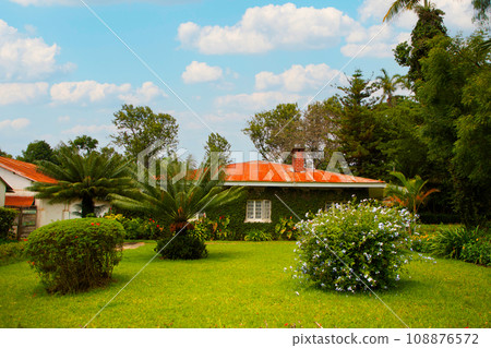 wealthy suburban mansion house with landscaped garden wealthy suburban mansion house with landscaped garden 108876572
