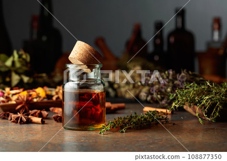 Essential herbal tincture in a small glass bottle. Essential herbal tincture in a small glass bottle. 108877350