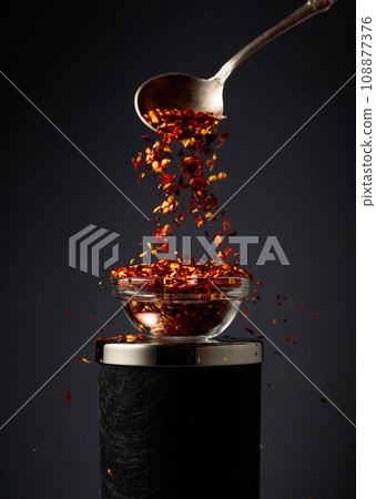 Flakes of red hot chili pepper. Flakes of red hot chili pepper. 108877376