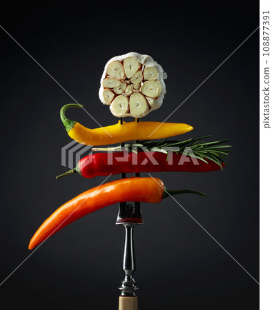 Red hot chili peppers with garlic and rosemary. 108877391