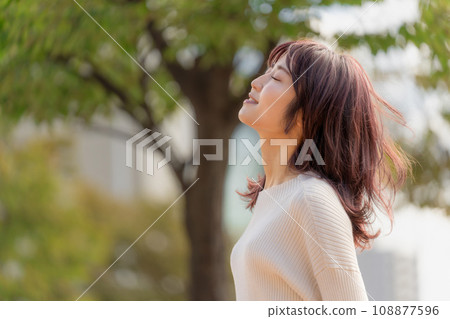 Profile of a woman thinking with her eyes closed and smiling Profile of a woman thinking with her eyes closed and smiling 108877596