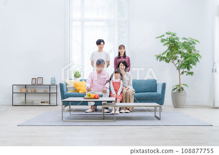 Three-generation family relaxing in the living room Three-generation family relaxing in the living room 108877755