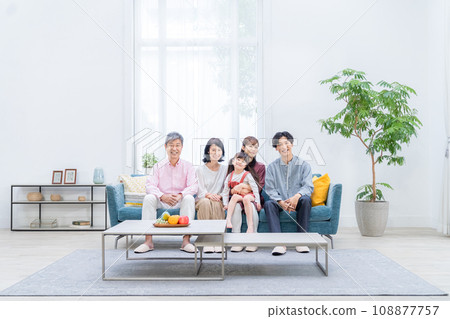Three-generation family relaxing in the living room Three-generation family relaxing in the living room 108877757