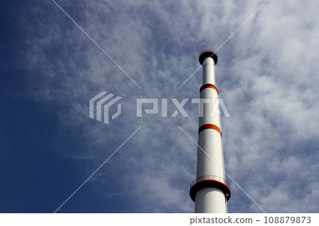 Garbage incinerator chimney painted white and red 108879873