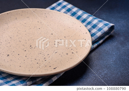 Round empty colored ceramic plate on concrete texture background 108880790
