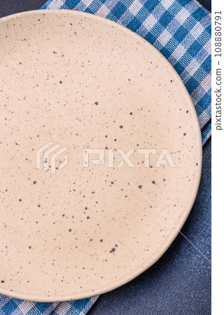 Round empty colored ceramic plate on concrete texture background 108880791