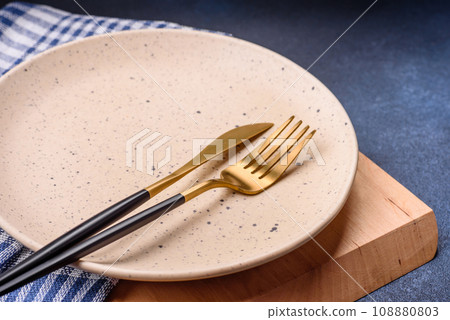 Round empty colored ceramic plate on concrete texture background 108880803