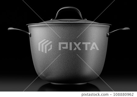 Stainless steel cooker with lid and chrome cookware on black background Stainless steel cooker with lid and chrome cookware on black background 108880962