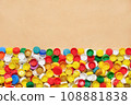 Collection of plastic caps on cardboard background. PET recycling plastic bottle cap recycling bottle cap PET plastic lids on recycling background. Sorting waste separation. Recyclable materials 108881838