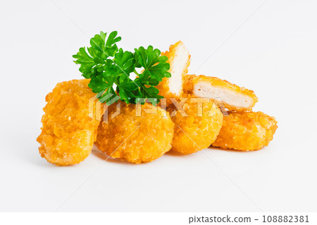 Breaded Chicken Inner Fillet on a White Background,Chicken Breaded Raw Meat.Chicken Breaded Fillet. Breaded chicken nuggets. Fast homemade food at home. Chicken breaded schnitzels. Fast cooking. 108882381