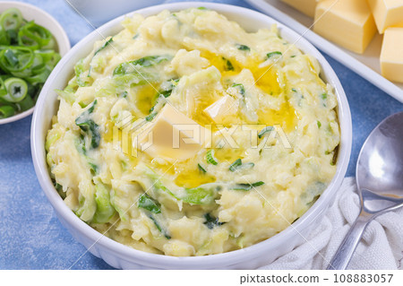 Traditional Irish dish Colcannon or mashed potato with green cabbage and butter, horizontal closeup 108883057