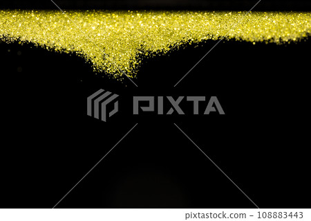Explosion metallic gold glitter sparkle. Golden Glitter powder spark blink celebrate, blur foil explode in air, fly throw gold glitters particle. Black background isolated, selective focus Blur bokeh 108883443