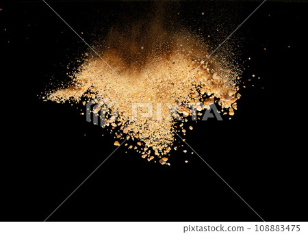 Big size Sand flying explosion, Golden grain wave explode. Abstract cloud fly. Yellow colored sand splash throwing in Air. Black background Isolated selective focus blur 108883475