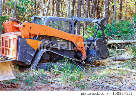 Forestry mulcher used by contractor for general purpose cleaning at forest 108884131