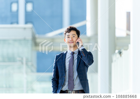 Male businessman talking on smartphone Male businessman talking on smartphone 108885668