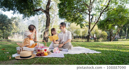 Happy senior grandparent together playing with little grandchild girl and party in park. Family leisure concept 108887090