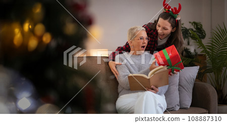 Caucasian Family, winter holiday and concept happy mother and daughter surprise decorating Christmas tree and give a gift at home Caucasian Family, winter holiday and concept happy mother and daughter surprise decorating Christmas tree and give a gift at home 108887310