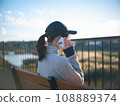 Woman talking on the phone in autumn park 108889374